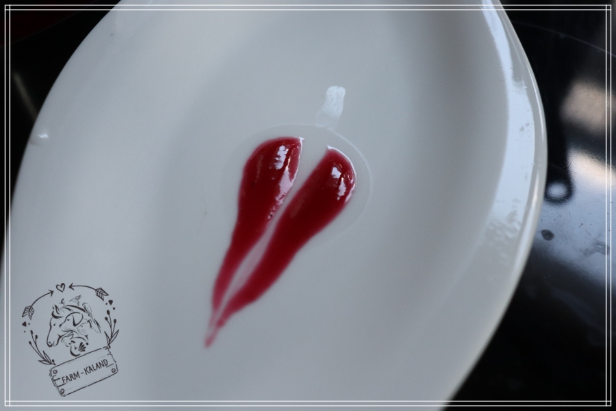 Ribizlilekvár csepp próba szemléltetése egy fehér tányéron